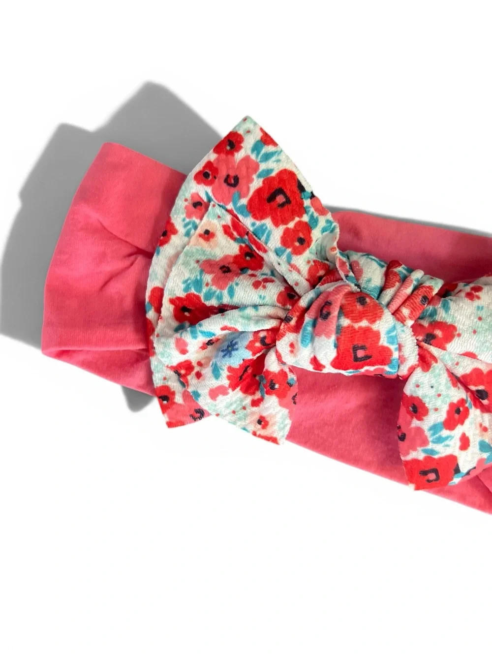 pink Ditsy Daisy knotted baby headband with a floral-patterned bow